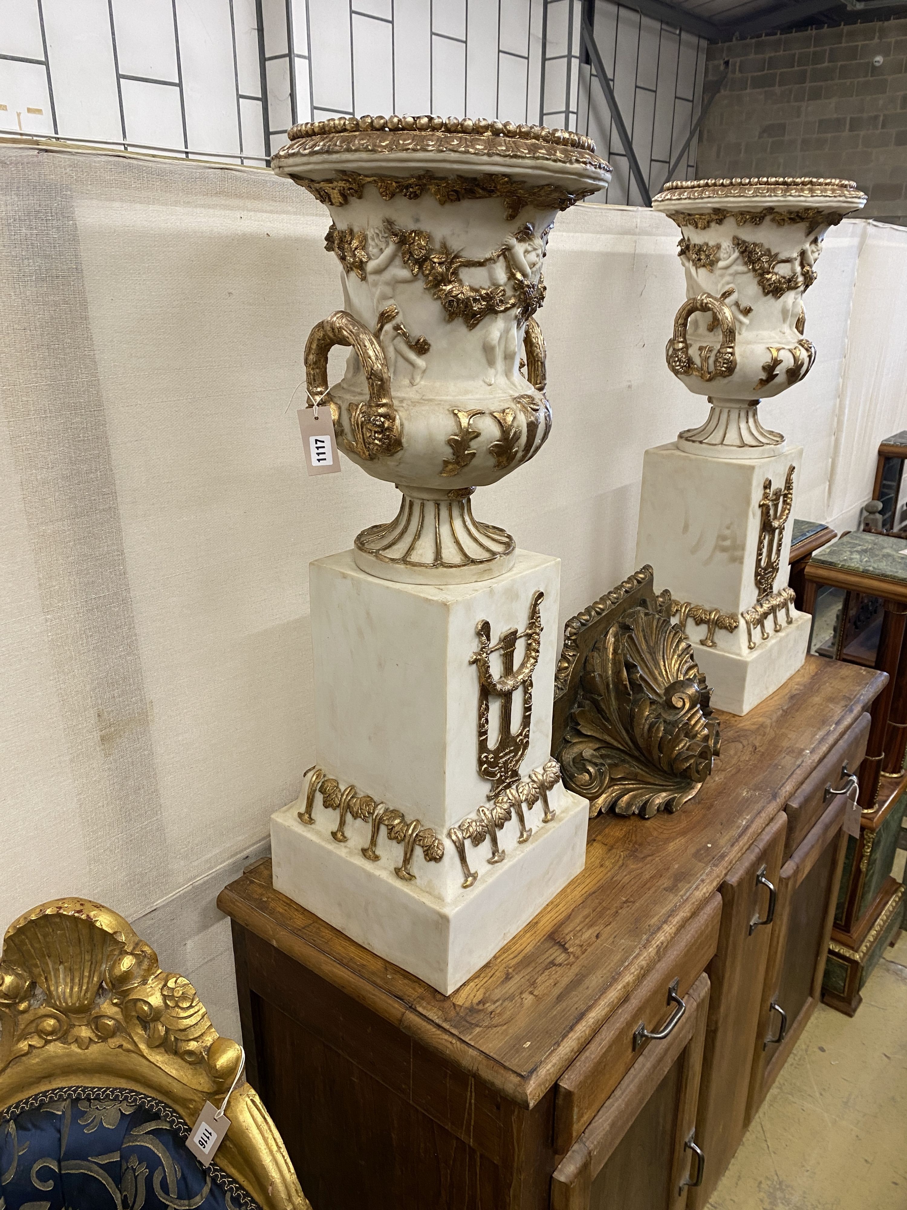 A pair of composition faux marble campana garden urns on stands, width 30cm, height 93cm